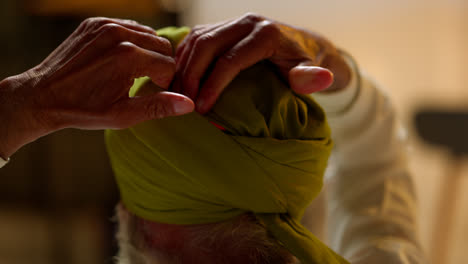 Close-Up-Studio-Shot-Of-Senior-Sikh-Man-With-Beard-Tying-Fabric-For-Turban-Viewed-From-Behind-Shot-In-Real-Time-2